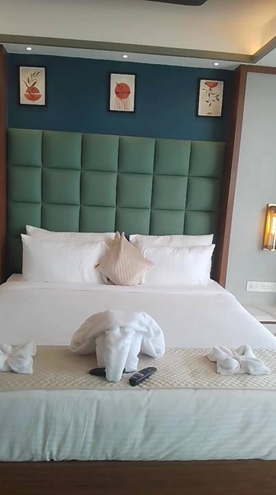 Bed dressed with a towel swan and petals