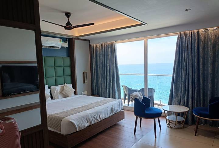Ocean View Deluxe room with king bed and sea through the windows